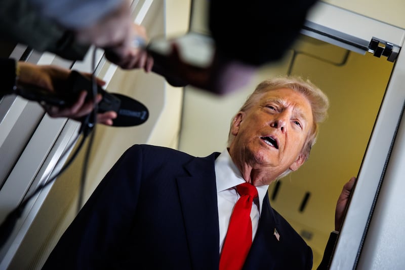 President Donald Trump speaks to members of the media on board Air Force One on October 31, 2025 at Joint Base Andrews, Maryland.