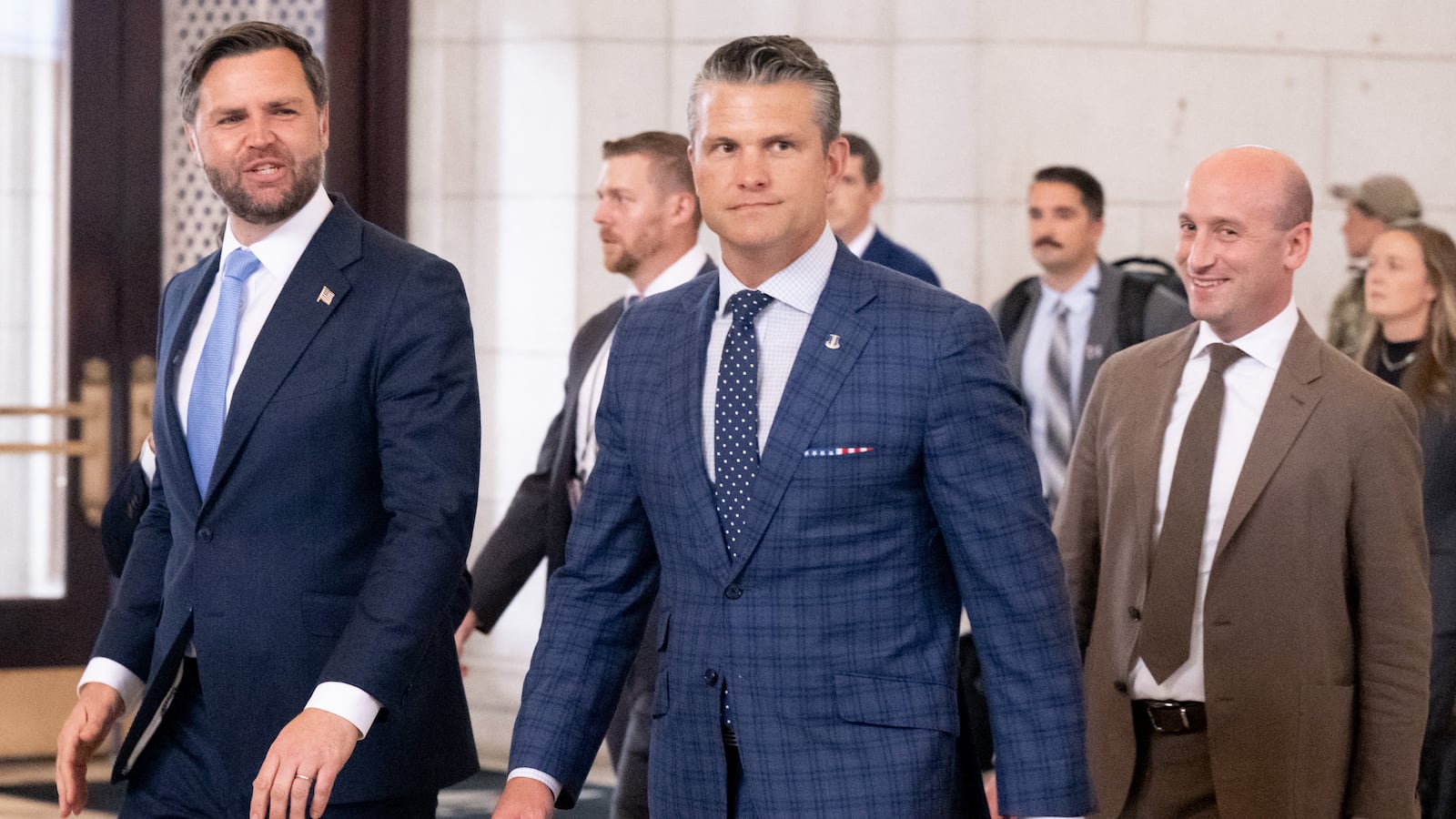 US Vice President JD Vance (L), Defense Secretary Pete Hegseth (C) and White House Deputy Chief of Staff Stephen Miller react to protesters as they leave after greetings members of the National Guard stationed at Union Station in Washington, DC, August 20, 2025.