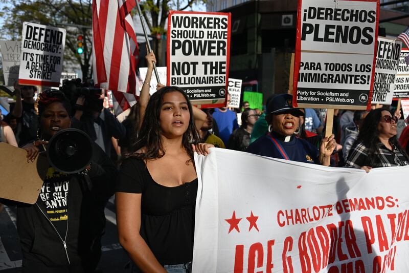 Protesters gather at First Ward Park for the 'No Border Patrol In Charlotte' rally to raise their voices for the immigrant community and against ICE raids and Border Patrol activity in Charlotte, North Carolina, US on November 15, 2025.