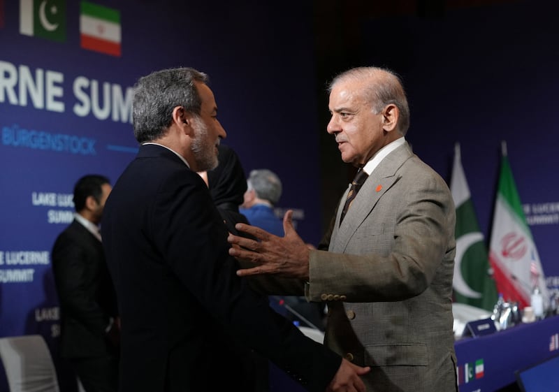 Iran's Foreign Minister Abbas Araqchi and Pakistan's Prime Minister Shehbaz Sharif greet each other before the start of a quadrilateral meeting between the U.S., Iran, Pakistan, and Qatar at the Lake Lucerne Summit, aimed at advancing a deal to end the Middle East conflict, at Buergenstock Resort Lake Lucerne, near Stansstad, Switzerland, June 21, 2026. REUTERS/Nathan Howard/Pool