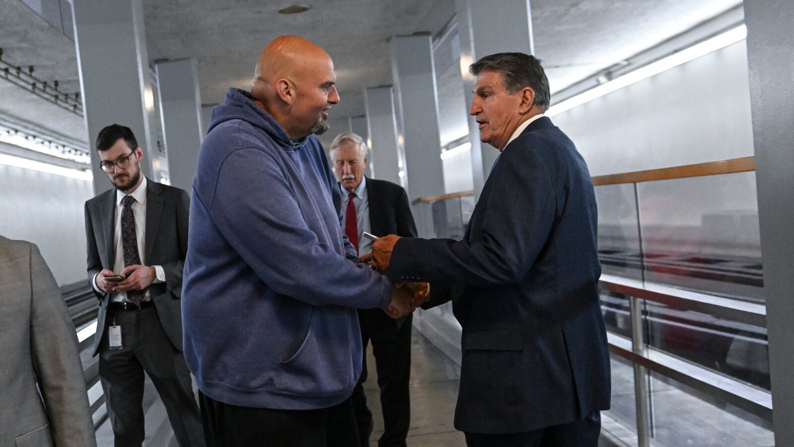Sen. John Fetterman (D-Pa.) has a quick exchange with Sen. Joe Manchin (D-W.Va.).