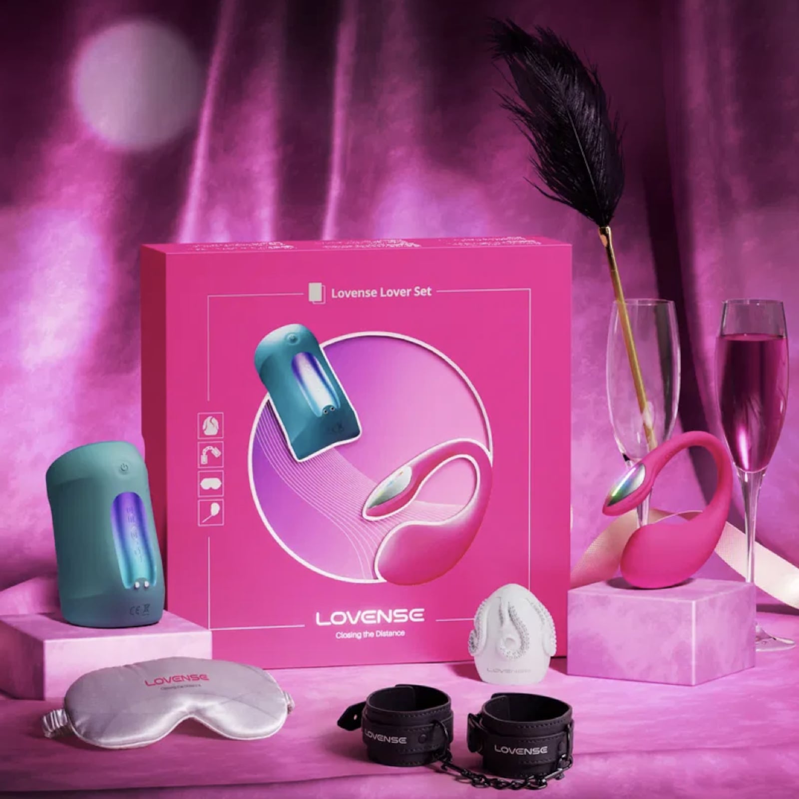 Lovense Lover Set displayed with toys and accessories including vibrator, massager, feather tickler, blindfold, and wrist cuffs in a romantic Valentine’s Day setting