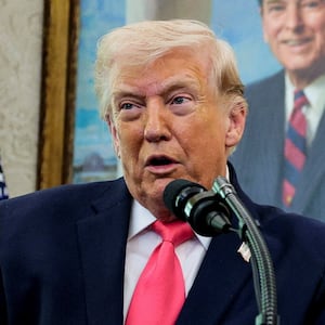 U.S. President Donald Trump speaks, with a portrait of former U.S. President Ronald Reagan in the background, as he attends Markwayne Mullin's swearing-in as Department of Homeland Security (DHS) Secretary, at the White House in Washington, D.C., U.S., March 24, 2026. REUTERS/Evan Vucci     TPX IMAGES OF THE DAY