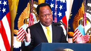 Leo Terrell, chair of the DOJ Task Force to Combat Antisemitism, and President Donald Trump, appear on stage during a Black History Month reception in the East Room of the White House on Wednesday, February 18, 2026.