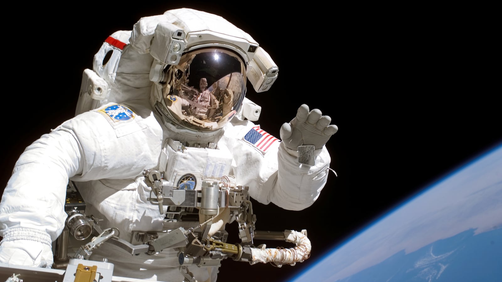 American astronaut Joseph Tanner waves to the camera during a space walk as part of the STS-115 mission to the International Space Station, September 2006. (Photo by NASA/Getty Images)