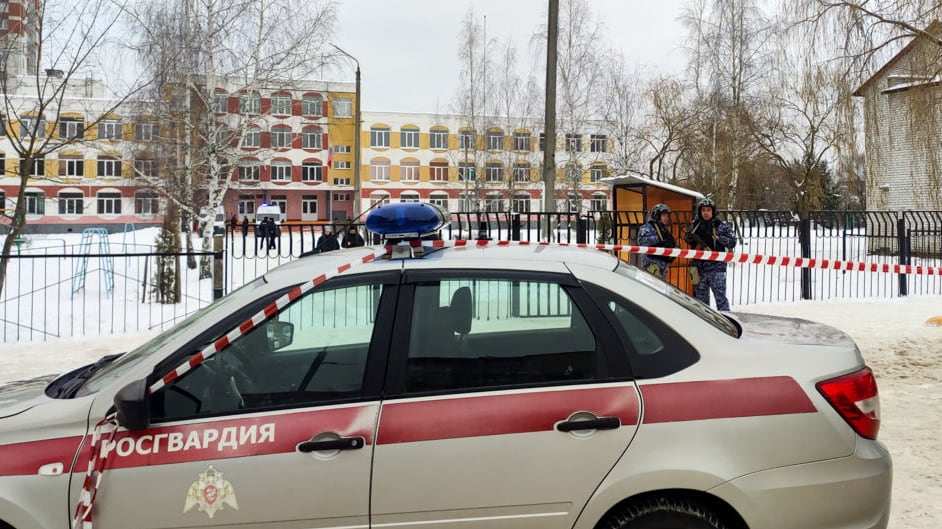 Law enforcement officers stand guard outside Gymnasium Number Five following a shooting, in Bryansk on December 7, 2023.