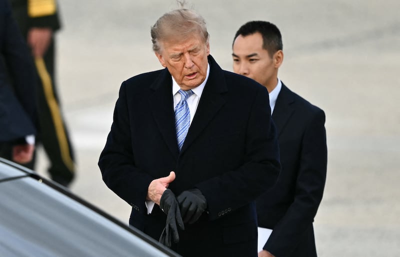 President Donald Trump puts his gloves back on after greeting Chinese President Xi Jinping and China's First Lady Peng Liyuan at Joint Base Andrews in Maryland on September 23, 2026.