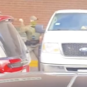 Border Patrol officer smashes the window of a car during the detention of a man. After Menards' security guard Ricardo Mendez filmed it, he was fired.