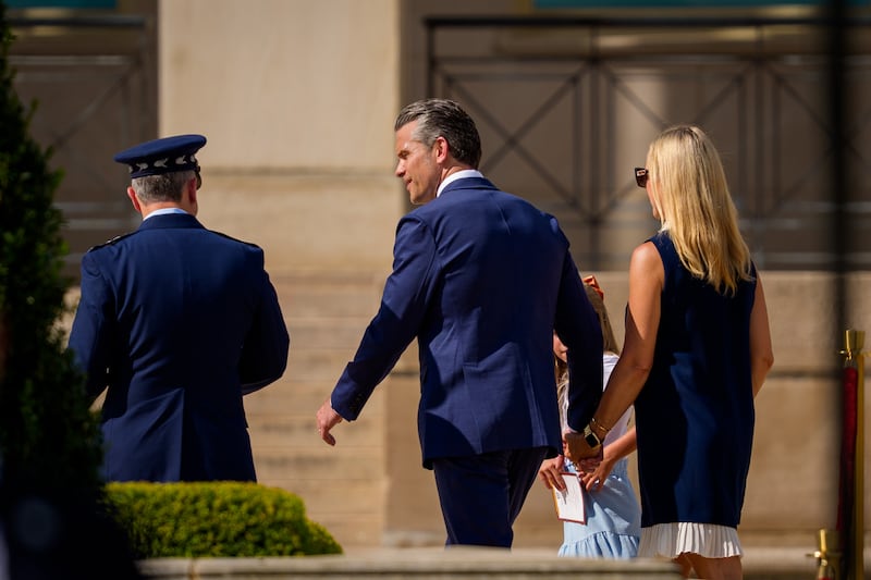ARLINGTON, VIRGINIA - SEPTEMBER 18: U.S. Secretary of War Pete Hegseth (C), his wife Jennifer Hegseth (R), and Chairman of the Joint Chiefs of Staff Air Force Gen. Dan Caine (L), depart following the Department of War's 2026 National POW/MIA Recognition Day Ceremony on the Pentagon River Terrace Parade Field on September 18, 2026 in Arlington, Virginia. The ceremony honored American service members who were held as prisoners of war and later returned home, as well as those still listed as missing in action from past conflicts. (Photo by Andrew Harnik/Getty Images)