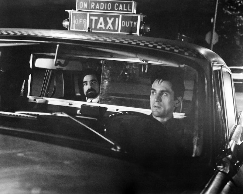 Director Martin Scorsese (left) as the 'Silhouette Watching Passenger', and Robert De Niro as Travis Bickle in 'Taxi Driver', directed by Scorsese, 1976