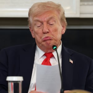WASHINGTON, DC - OCTOBER 08: U.S. President Donald Trump reads a note handed to him by U.S. Secretary of State Marco Rubio he said was regarding Middle East peace talks during a roundtable discussion in the State Dining Room of the White House on October 08, 2025 in Washington, DC. Trump’s administration held the roundtable to discuss the anti-fascist Antifa movement after signing an executive order designating it as a “domestic terrorist organization”. (Photo by Anna Moneymaker/Getty Images)
