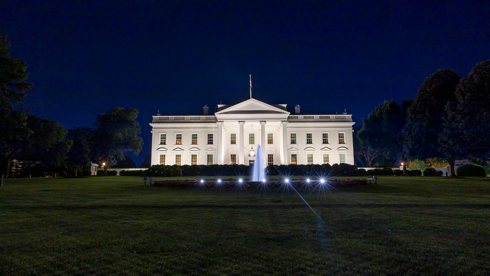 Exterior view of the Northern side of the White House illuminated during the night in Washington DC.