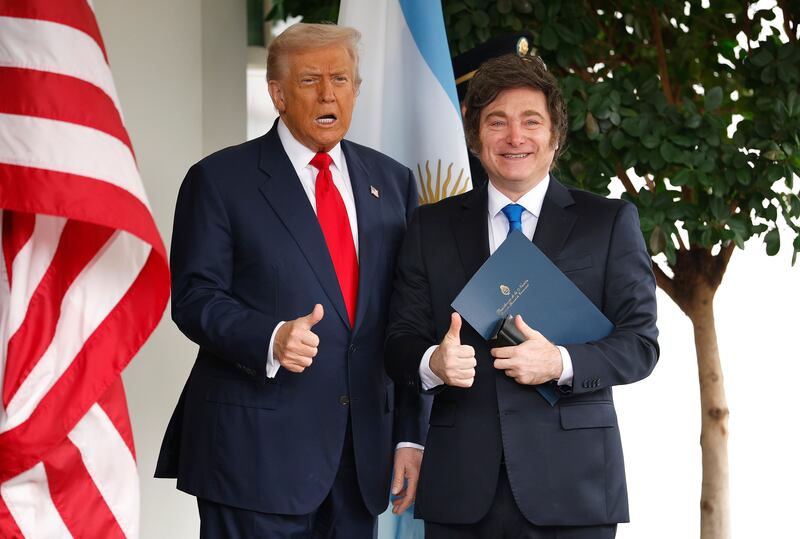 U.S. President Donald Trump (L) greets President of Argentina Javier Milei as he arrives at the West Wing of the White House on October 14, 2025 in Washington, DC.