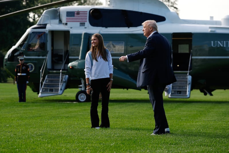 President Donald Trump and his granddaughter, Kai Trump, walk to Marine One on the South Lawn of the White House