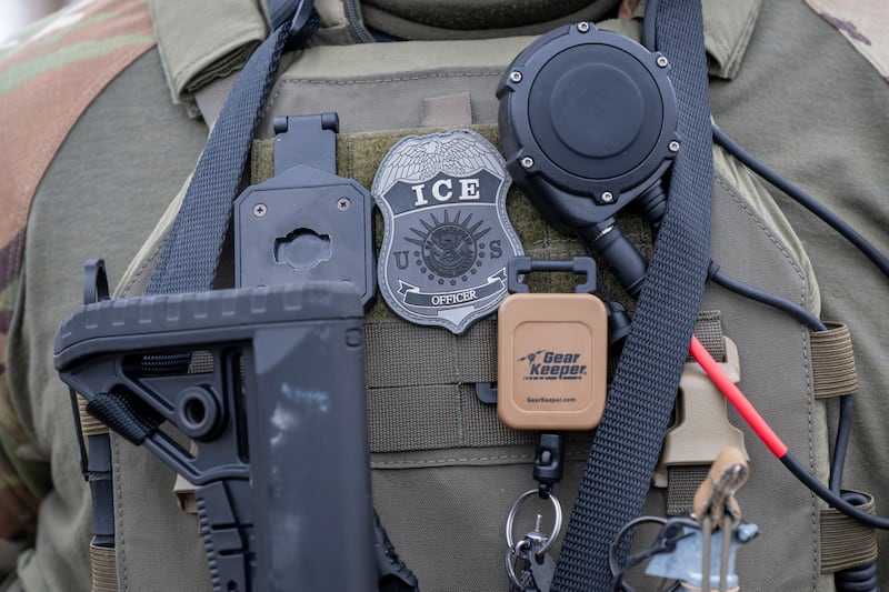 Closeup of ice officers badge and gear.