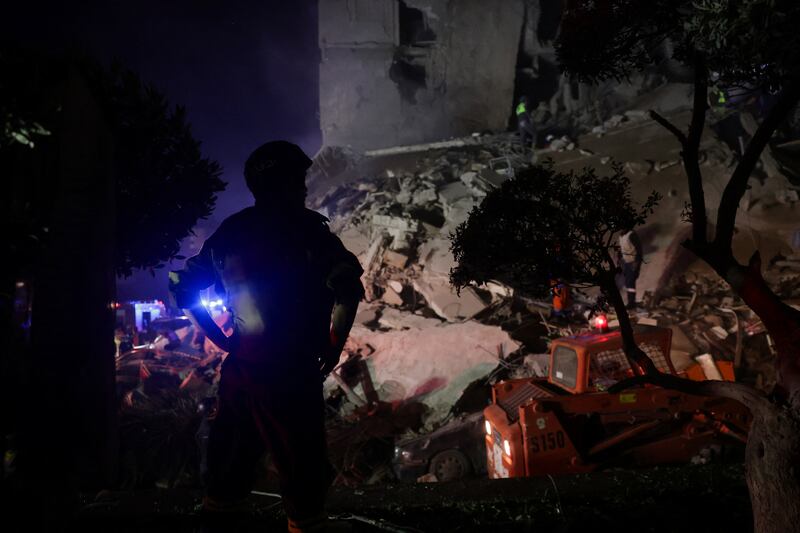 A rescuer looks on as others save people from a damaged building following an Israeli strike, in Beirut, Lebanon, April 8, 2026.  REUTERS/Emilie Madi