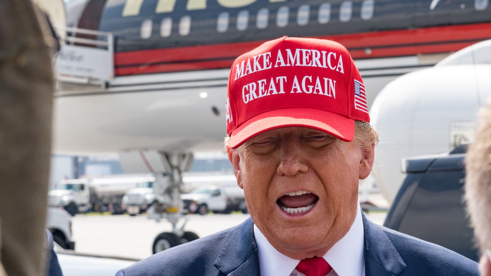 Former U.S. President Donald Trump speaks to the media as he arrives at the Atlanta Airport.