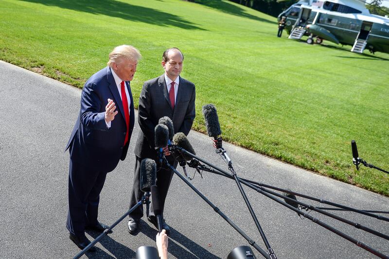 President Donald Trump and his Labor Secretary Alexander Acosta speak to the media on the South Lawn of the White House on July 12, 2019.