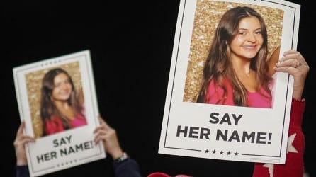 Posters of Laken Riley with the words “say her name” under them.