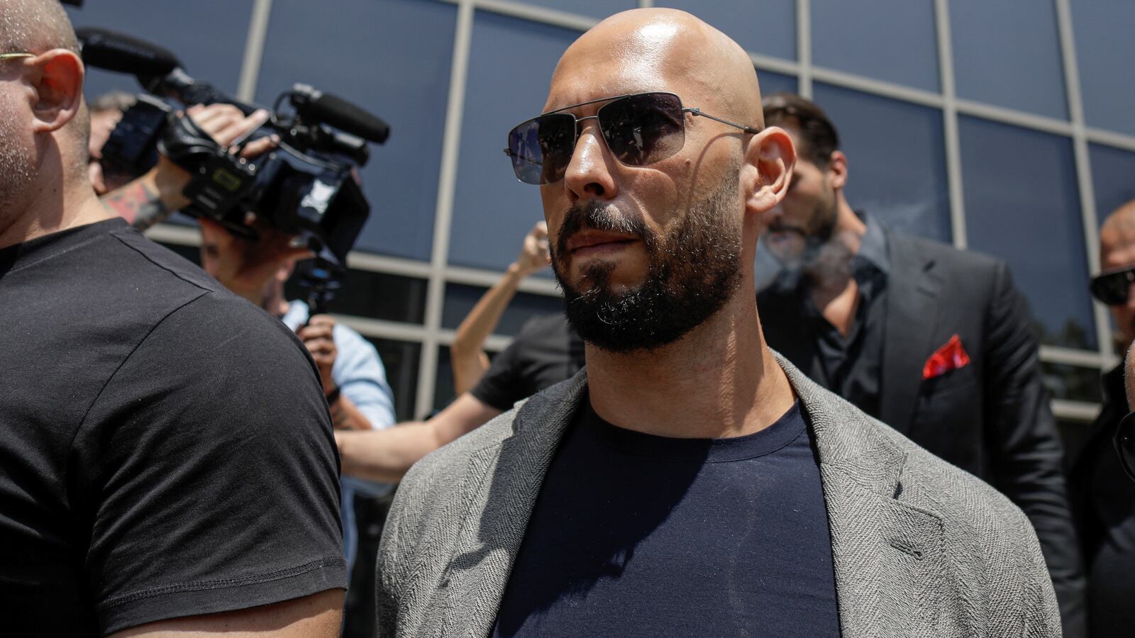 Andrew Tate, escorted by bodyguards, leaves the Bucharest Tribunal in Bucharest, Romania, June 21, 2023.