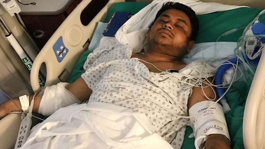 Maruf Hossain in a hospital bed