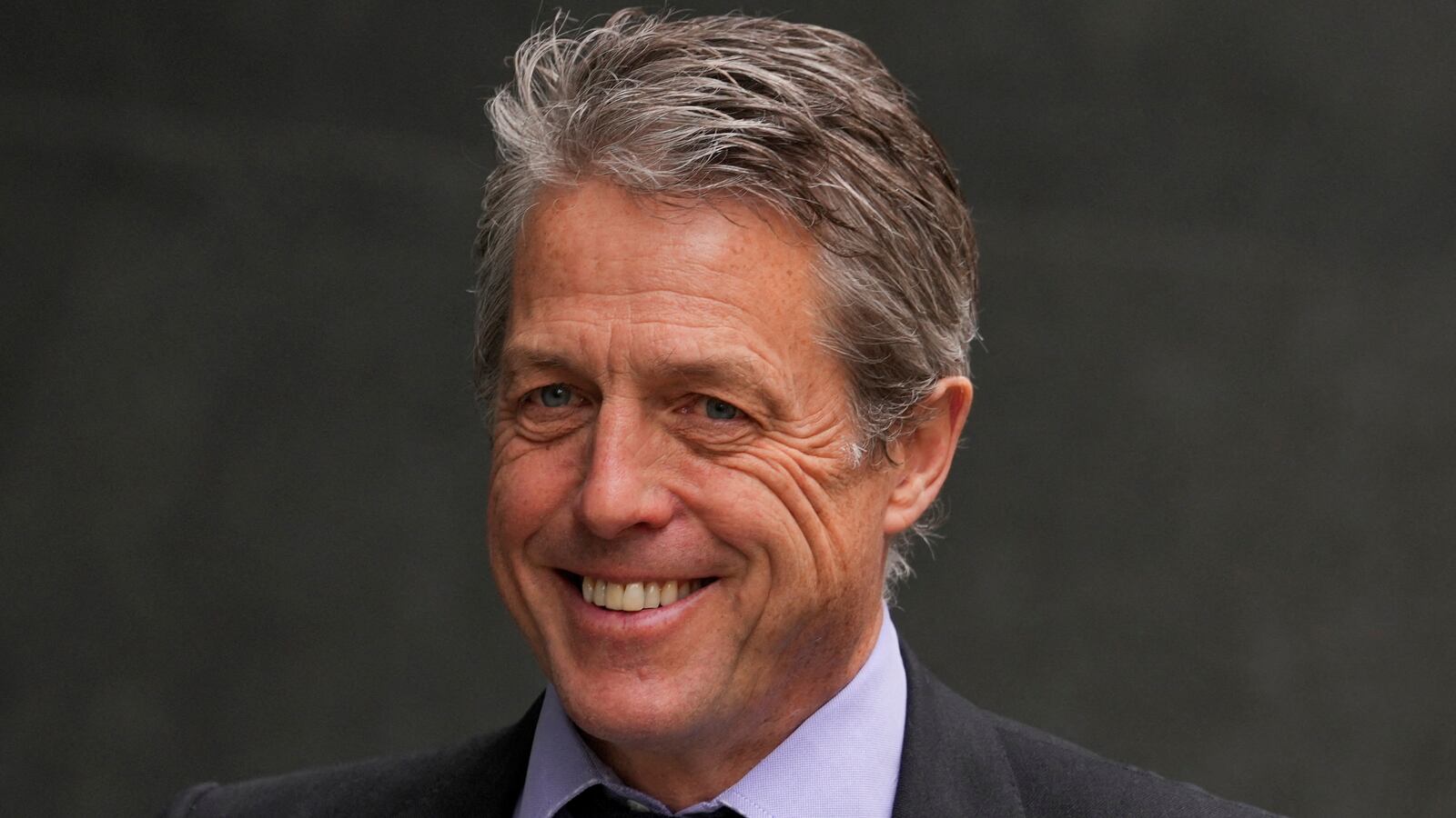 Hugh Grant walks outside the High Court in London, Britain, April 27, 2023.