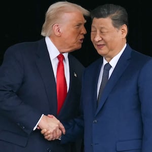 President Donald Trump (L) and China’s President Xi Jinping shake hands as they leave after their talks at the Gimhae Air Base on October 30, 2025.