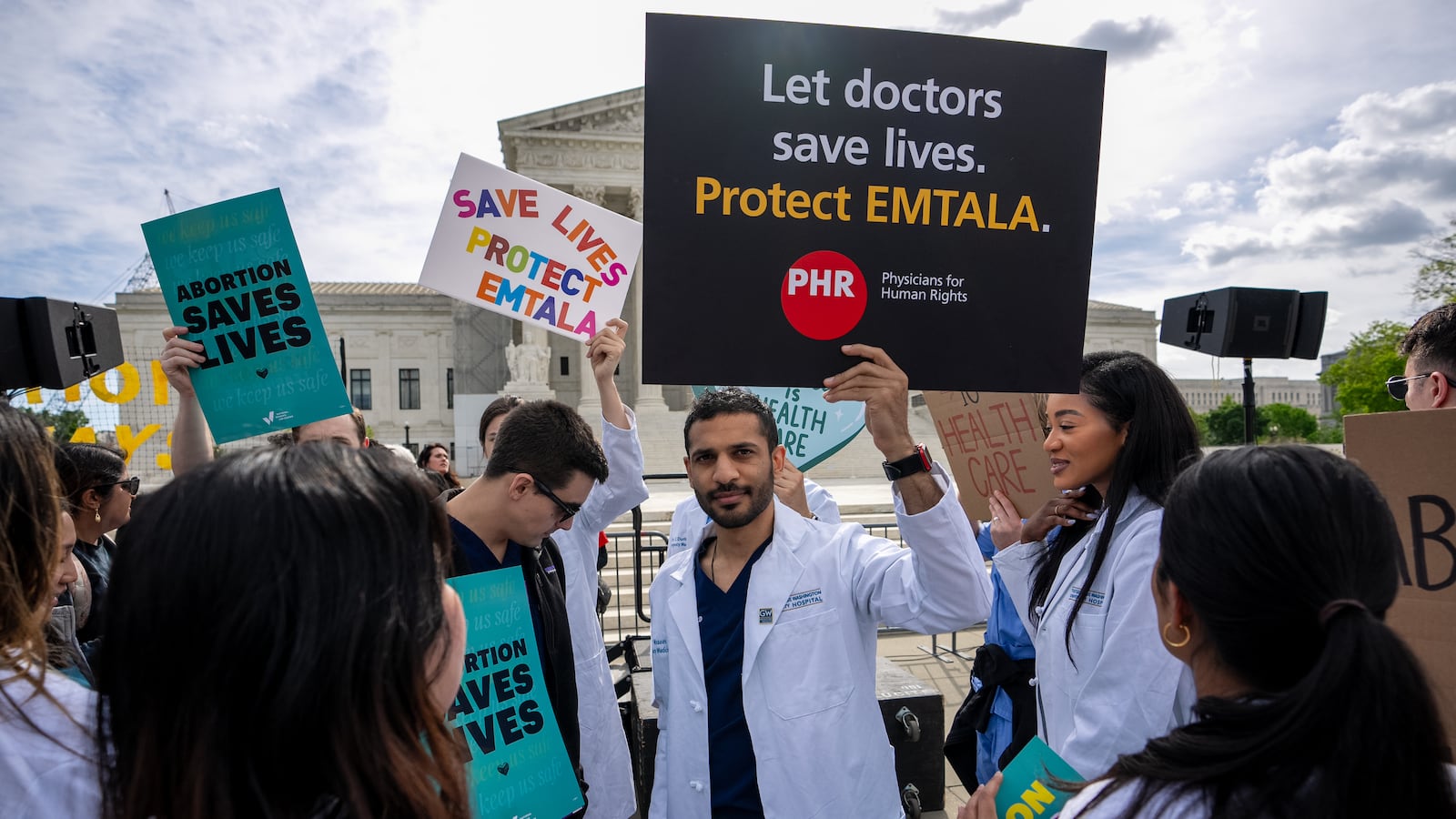 A group of doctors join abortion rights supporters at a rally outside the Supreme Court in Washington, D.C.