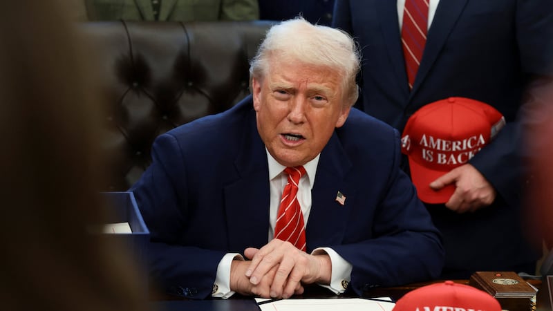 U.S. President Donald Trump sits behind a bill he signed to end the partial government shutdown, at the White House in Washington, D.C., U.S., February 3, 2026. REUTERS/Evelyn Hockstein