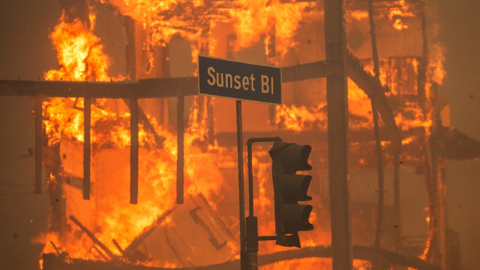 Flames from the Palisades Fire burn a building on Sunset Boulevard amid a powerful windstorm on January 8, 2025 in the Pacific Palisades neighborhood of Los Angeles, California.