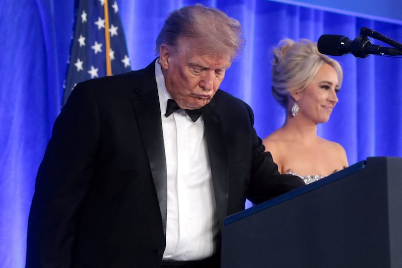 U.S. President Donald Trump, with incoming White House Correspondents' Association (WHCA) President and Fox News Senior White House Correspondent Jacqui Heinrich, takes the lectern to deliver remarks at the WHCA Dinner, which was rescheduled from April after it was interrupted when a man tried to force his way through security and fired a shotgun, at the Waldorf Astoria hotel in Washington, D.C., U.S., July 24, 2026