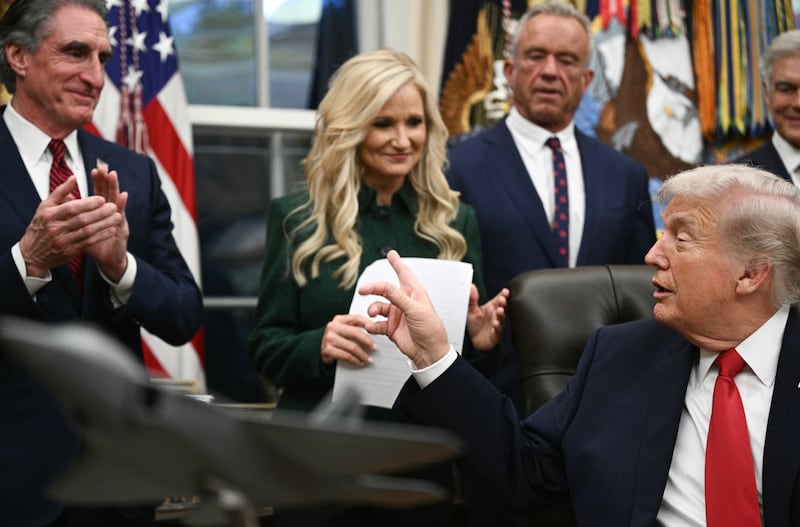 US President Donald Trump gestures to (L-R) US Secretary of the Interior Doug Burgum, Kathryn Burgum, US Secretary of Health and Human Services Robert F. Kennedy Jr. and Medicare and Medicaid Administrator Mehmet Oz  after signing the "Great American Recovery Initiative" aimed at combating addiction and substance abuse in the Oval Office of the White House in Washington, DC, on January 29, 2026. (Photo by Brendan SMIALOWSKI / AFP via Getty Images)