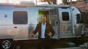 Spencer Pratt emerging from a trailer.