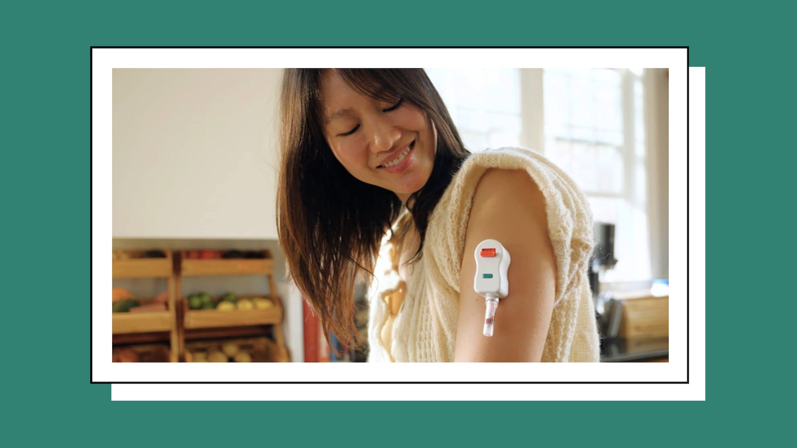 A smiling woman displays a SiPhox Health EasyDraw blood collection device attached to her upper arm.