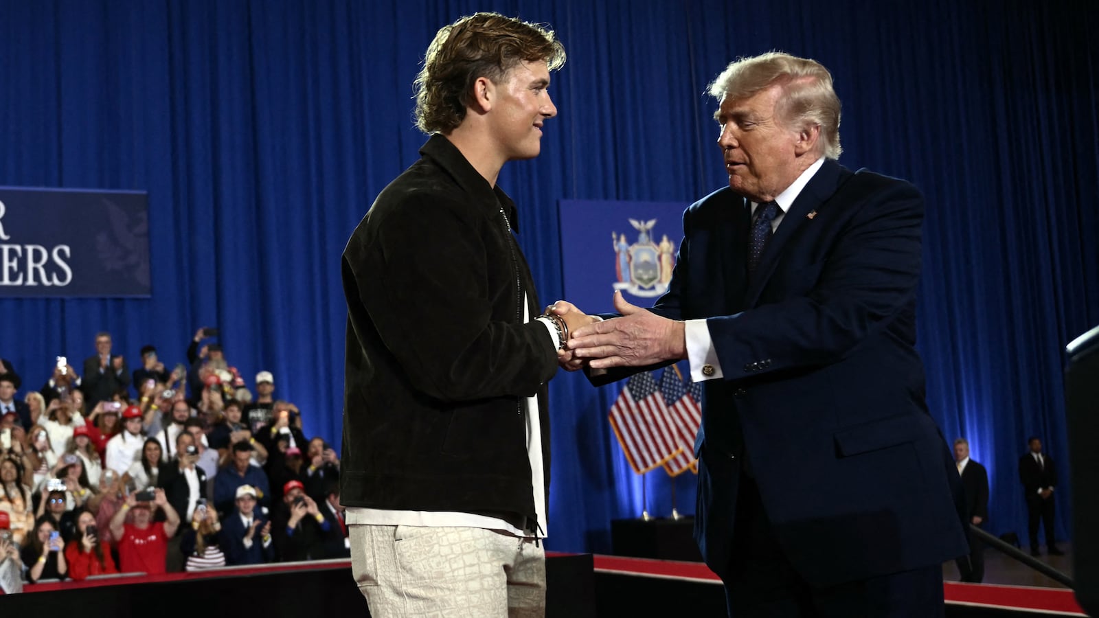 New York Giants quarterback Jaxson Dart welcomes Trump before delivering a speech about the economy at Rockland Community College Fieldhouse in Suffern, New York, on May 22, 2026.