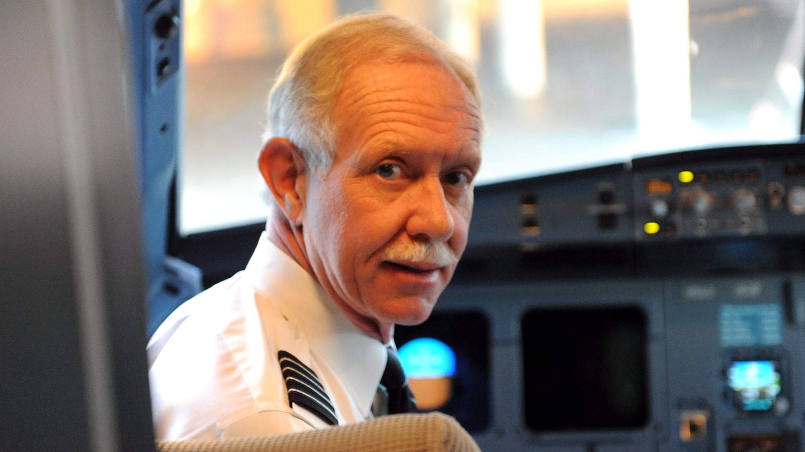 Captain Sullenberger in a cockpit of an aircraft