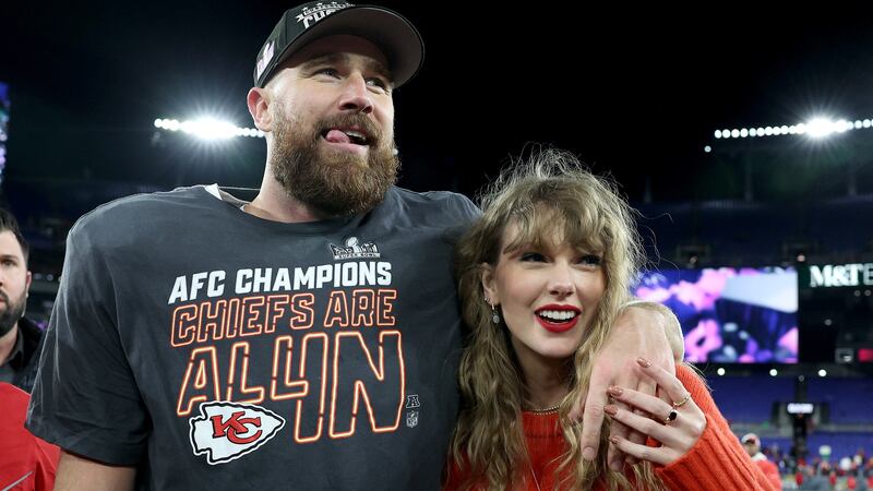 Travis Kelce #87 of the Kansas City Chiefs celebrates with Taylor Swift after a 17-10 victory.