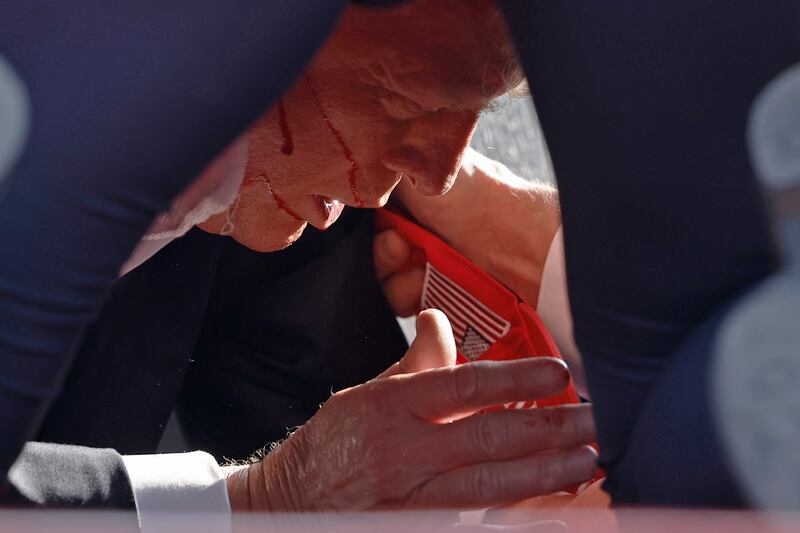 BUTLER, PENNSYLVANIA - JULY 13: Secret Service tend to republican presidential candidate former President Donald Trump onstage at a rally on July 13, 2024 in Butler, Pennsylvania.
