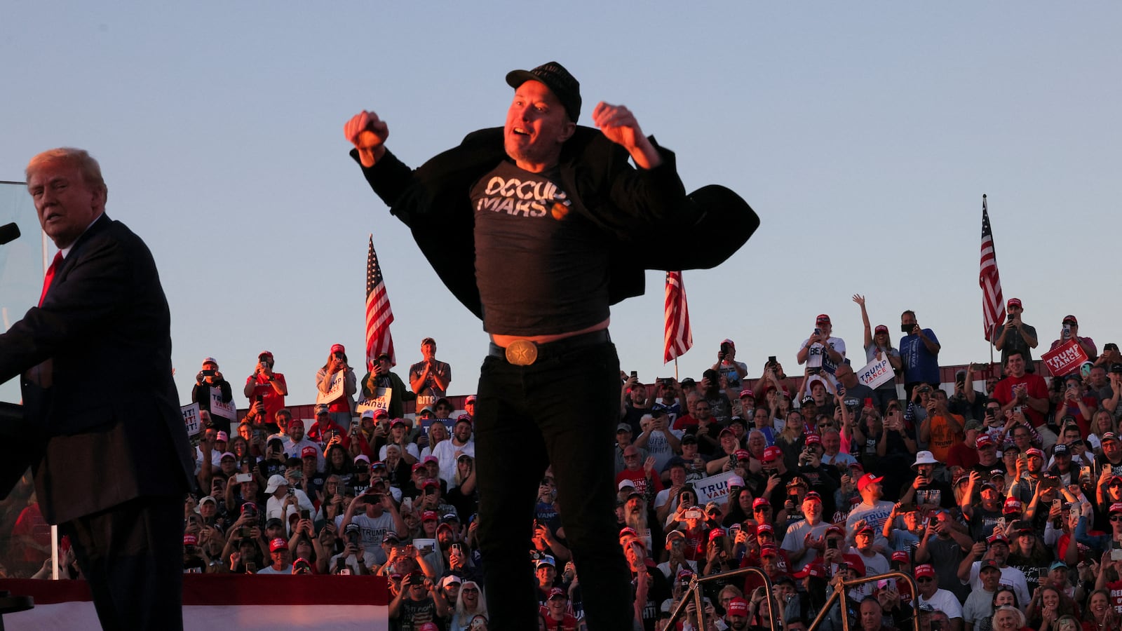 Tesla CEO and X owner Elon Musk jumps on the rally stage.