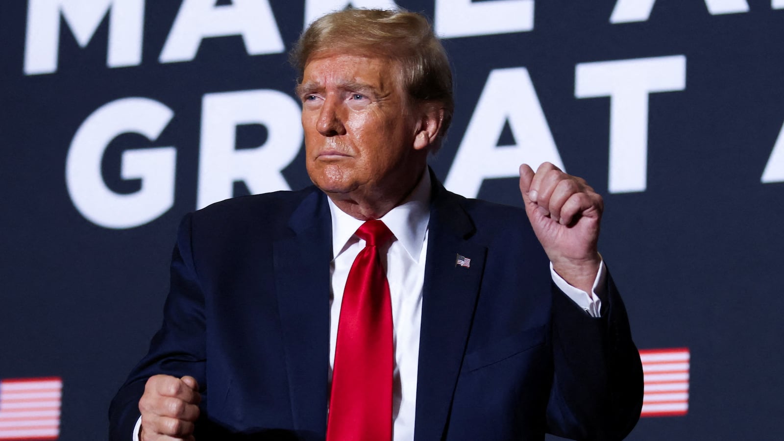Donald Trump dances on stage at a campaign event.