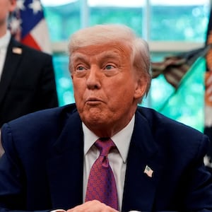 U.S. Senator Ashley Moody (R-FL) and U.S. Representative Craig Goldman (R-TX) stand behind U.S. President Donald Trump in the Oval Office of the White House, in Washington, D.C., U.S., May 9, 2025. REUTERS/Kent Nishimura