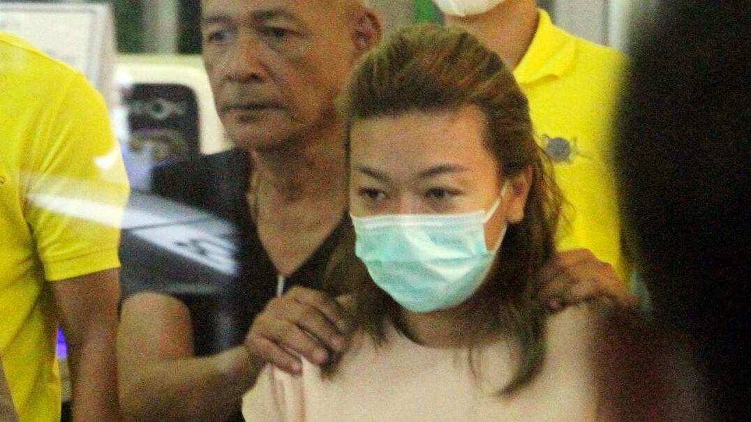 Sararat Rangsiwuthaporn, a suspect in over a dozen murders, is escorted by police officers at a police station in Bangkok, Thailand, April 26, 2023.