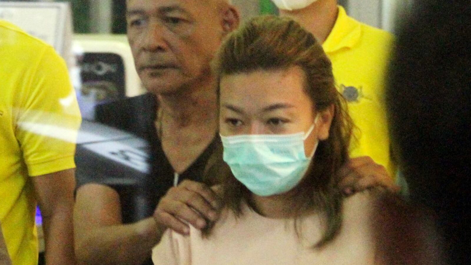 Sararat Rangsiwuthaporn, a suspect in over a dozen murders, is escorted by police officers at a police station in Bangkok, Thailand, April 26, 2023.