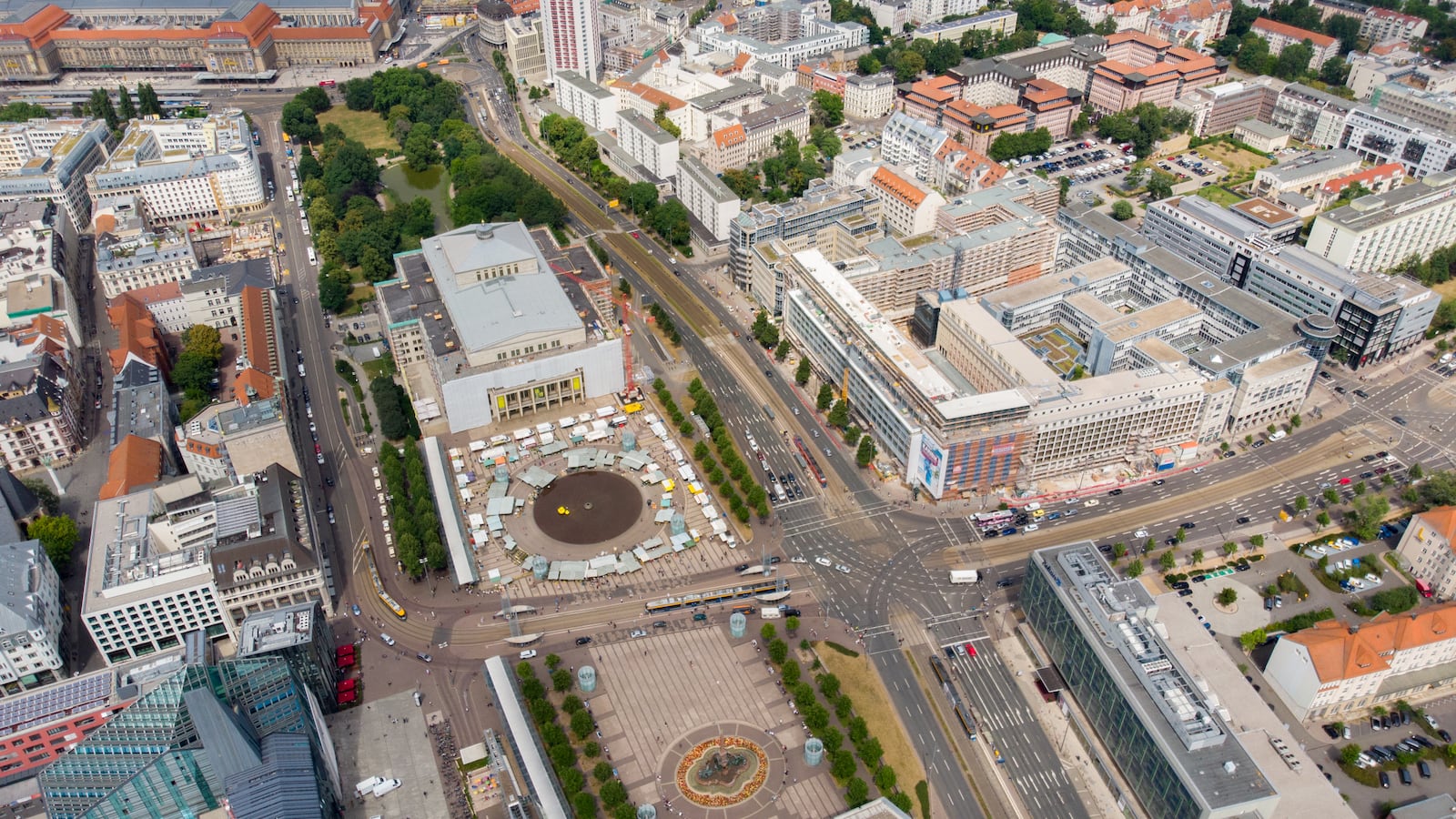 Aerial view of Leipzig city center in Germany featuring modern skyline architecture prominent MDR Tower and the open square of Augustusplatz surrounded by urban buildings and streets ideal for themes of city life business travel architecture and European urban landscapes
