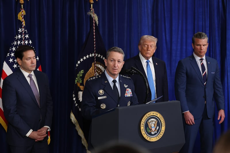 President Donald Trump with his eyes closed as Chairman of the Joint Chiefs of Staff Dan Caine speaks during a press conference at Mar-a-Lago club on January 03, 2026, in Palm Beach, Florida.