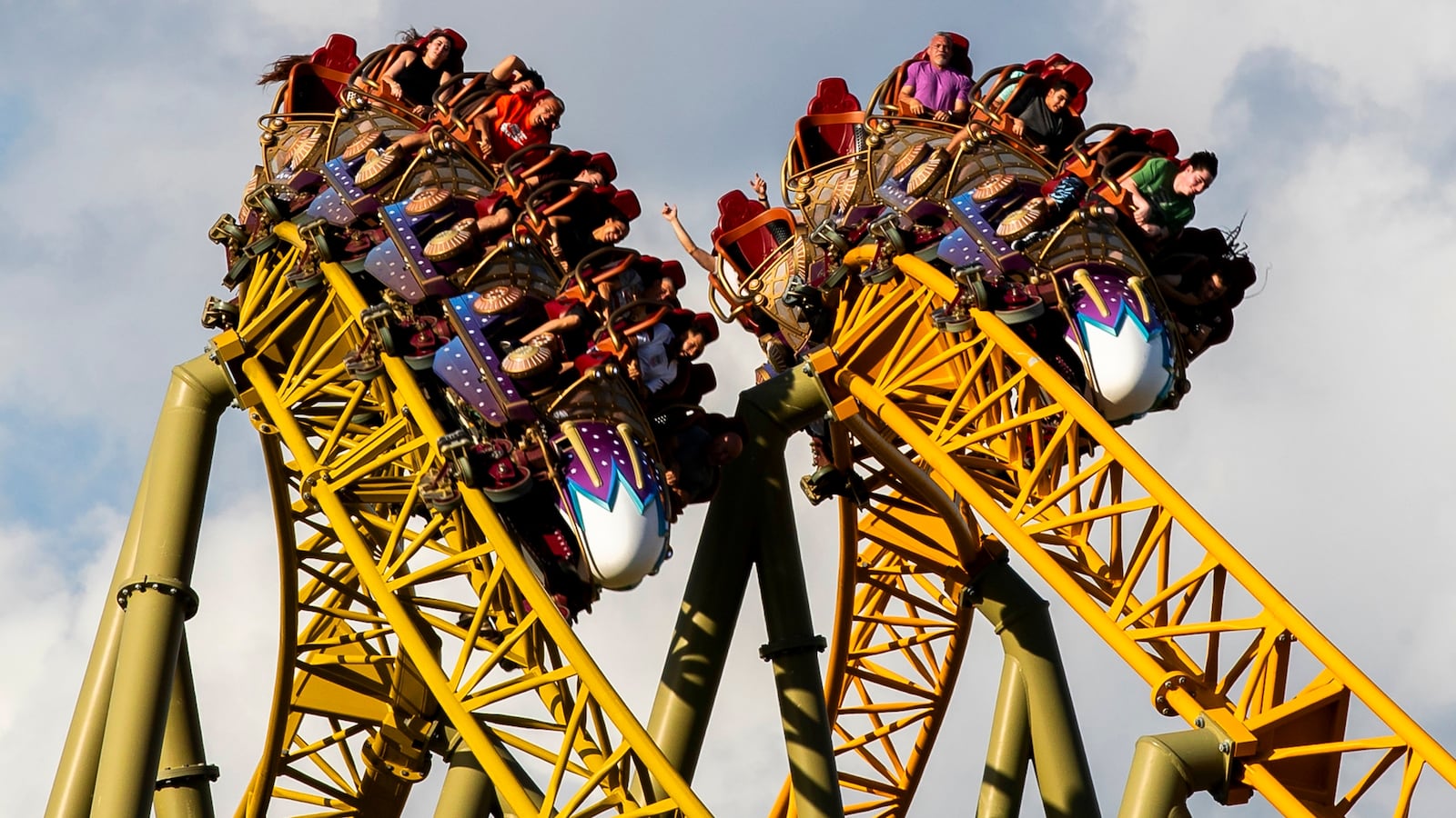 Guests ride Stardust Racers, a new dueling roller coaster ride in Celestial Park
