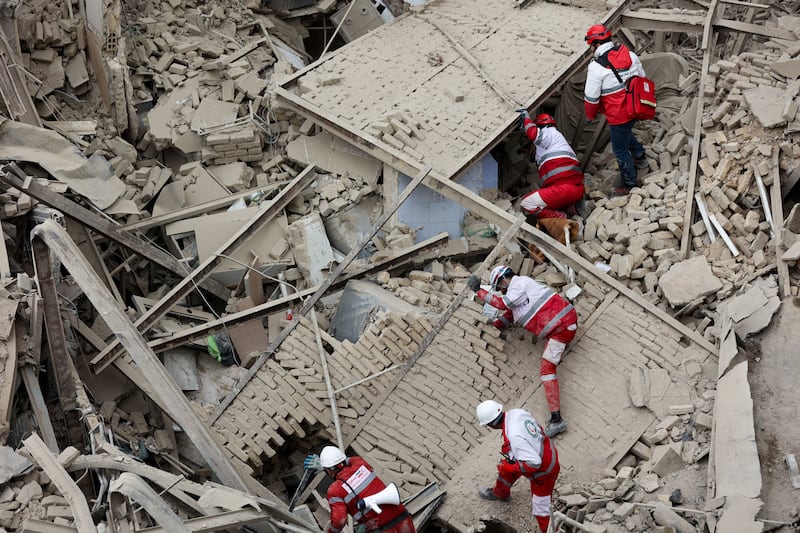 Emergency personnel work at the site of a strike on a residential building, amid the U.S.-Israeli conflict with Iran, in Tehran, Iran, March 16, 2026. Majid Asgaripour/WANA (West Asia News Agency) via REUTERS ATTENTION EDITORS - THIS PICTURE WAS PROVIDED BY A THIRD PARTY     TPX IMAGES OF THE DAY