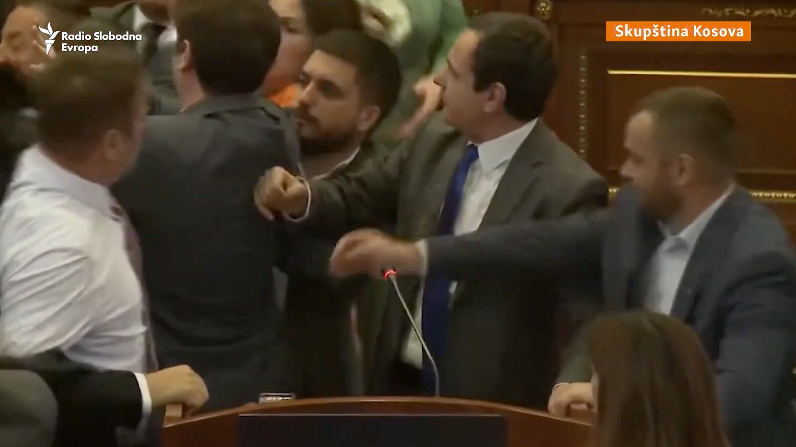 Kosovo lawmakers fight in the Assembly as Prime Minister Albin Kurti delivers a speech.