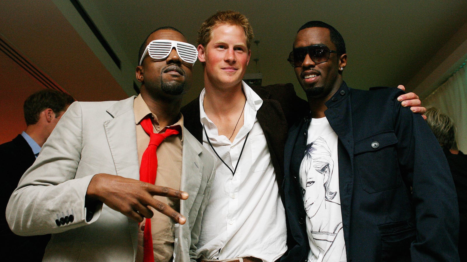Kanye West (L) poses with Prince Harry (C) and US rapper P Diddy (R) at Wembley Arena in north London, 01 July 2007