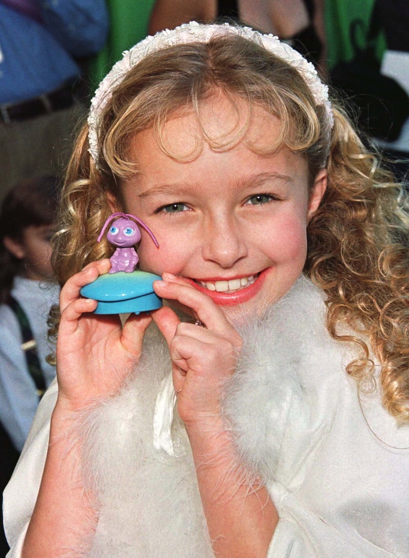 Actress Hayden Panettiere, who provides the voice for the ant character Princess Dot in the new computer animated film "A Bug's Life," from Walt Disney Pictures and Pixar Animation Studios, poses with a Princess Dot toy at the film's premiere on November 14. The film, which tells the story of  a world populated by bugs of every shape and size, opens in the United States on November 25.